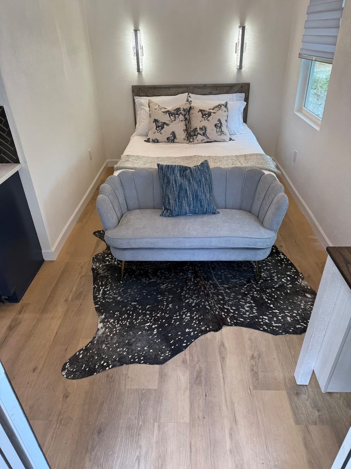 Bed and loveseat seen from across the cabin