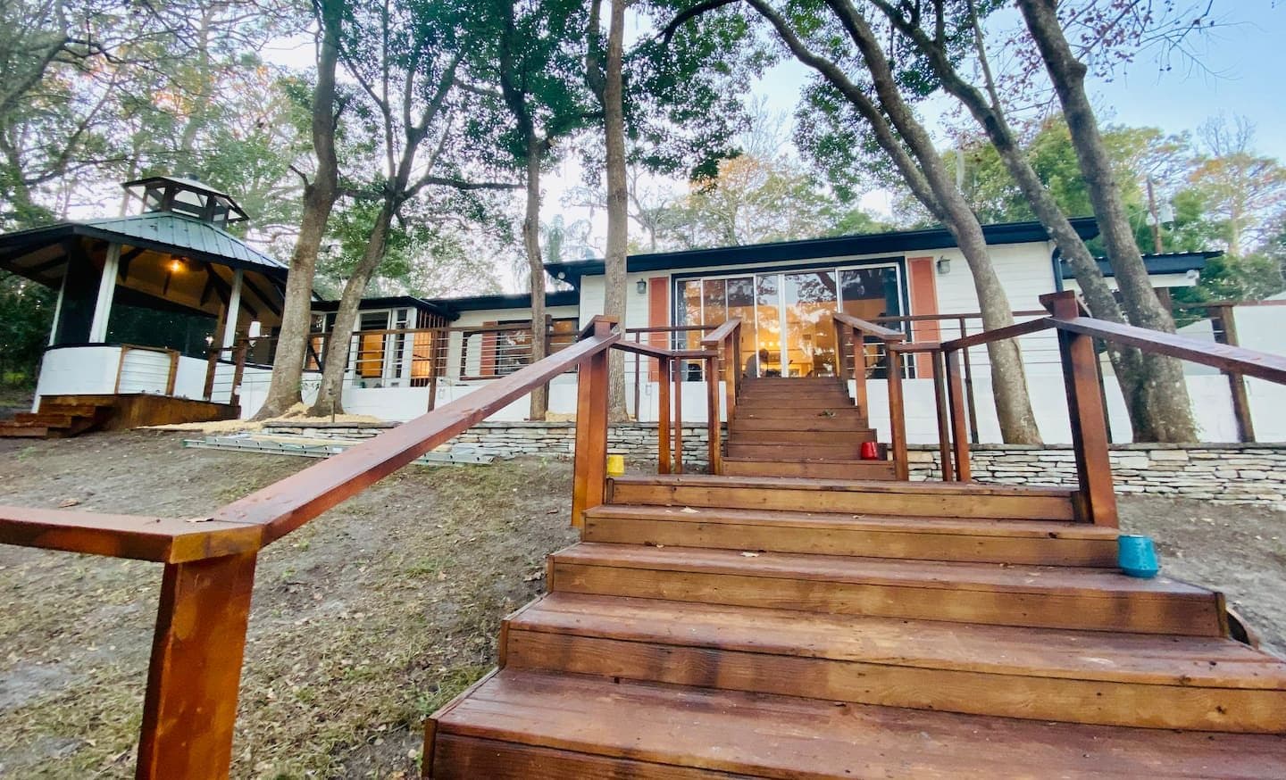 Wooden steps leading up to the Cottage and its gazebo among the trees