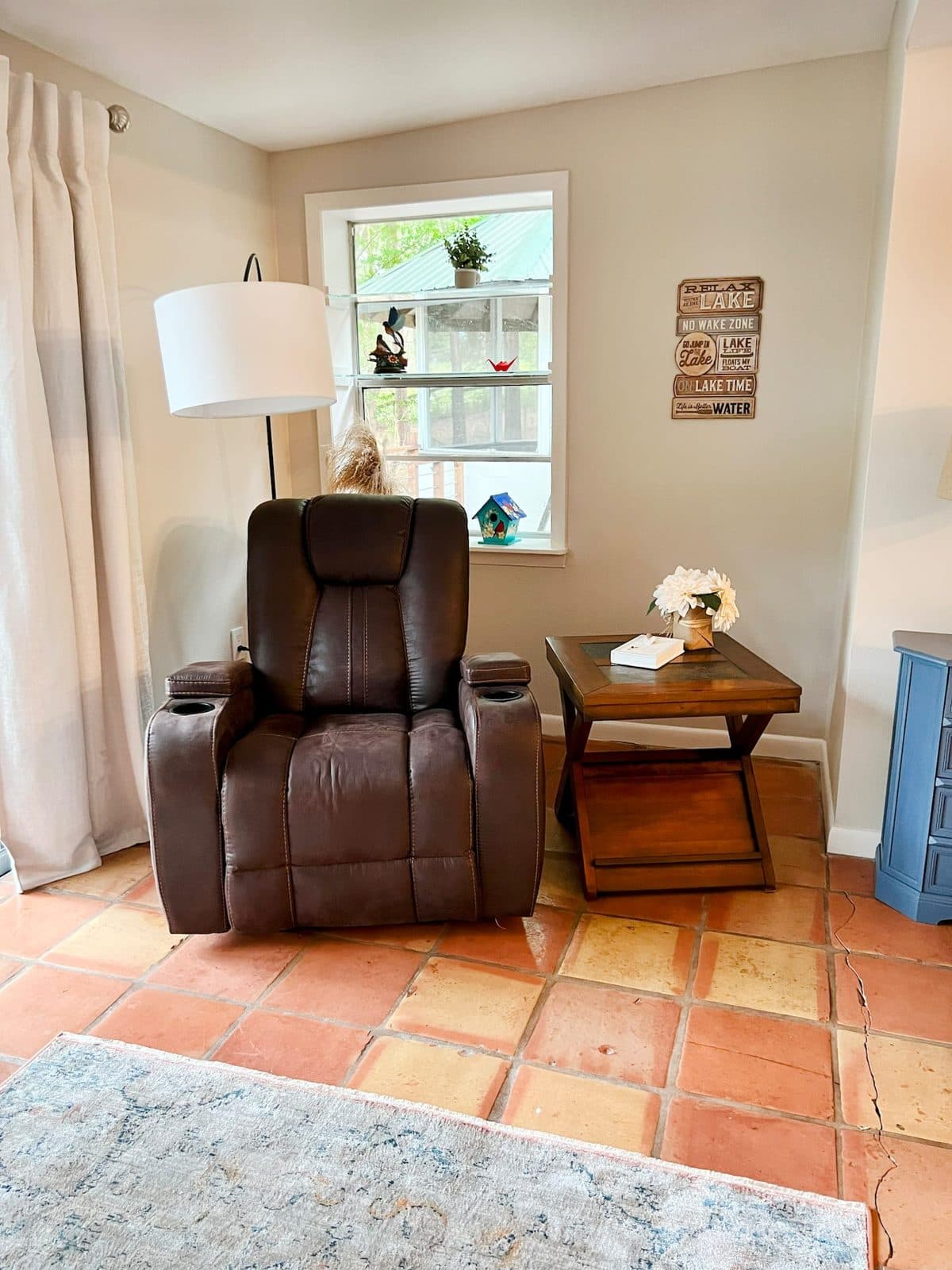 Corner reading nook with a recliner, side table and window